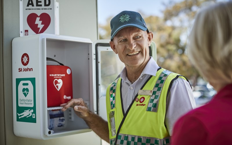 St John Ambulance officer Infront of defib device