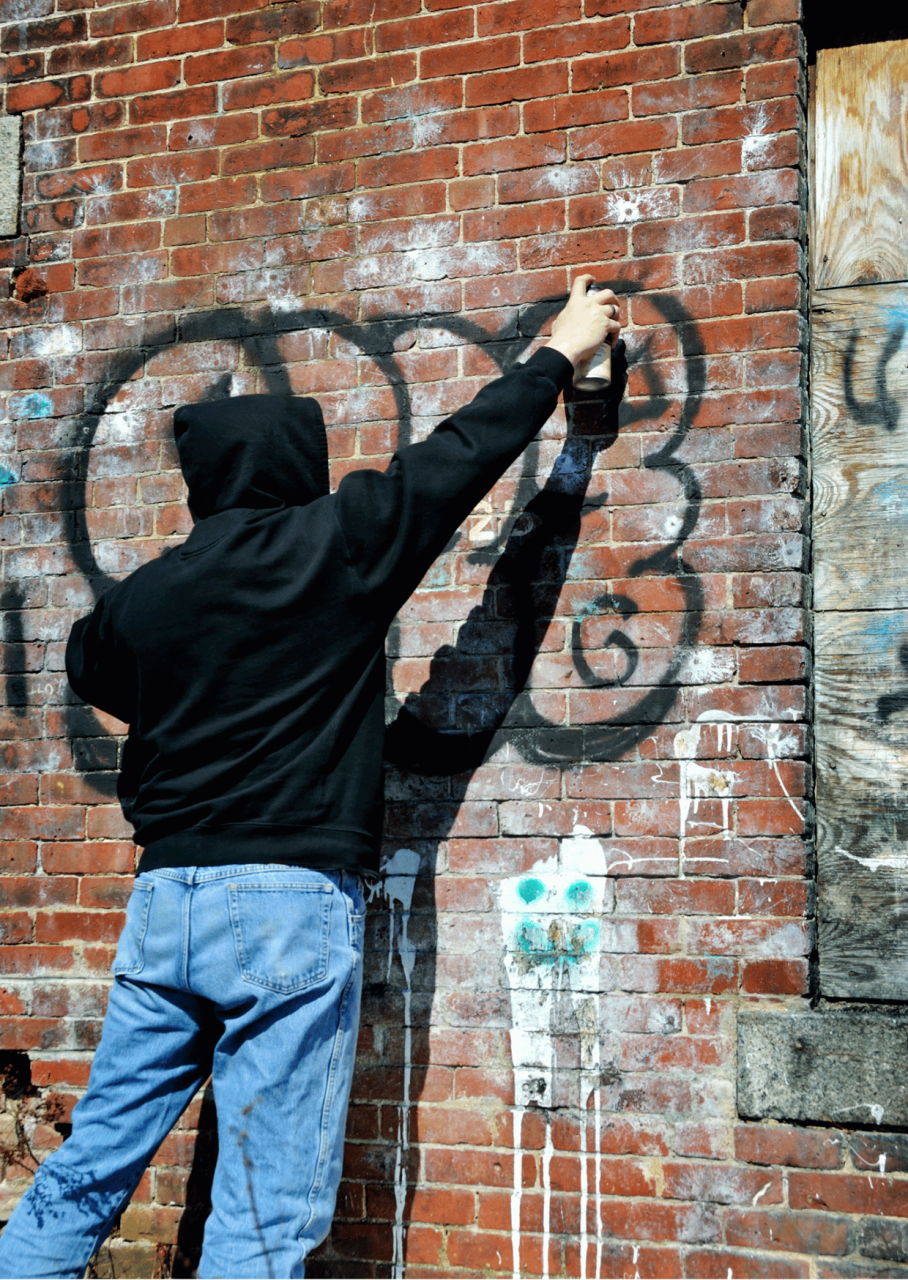 Man spraying graffiti on a wall