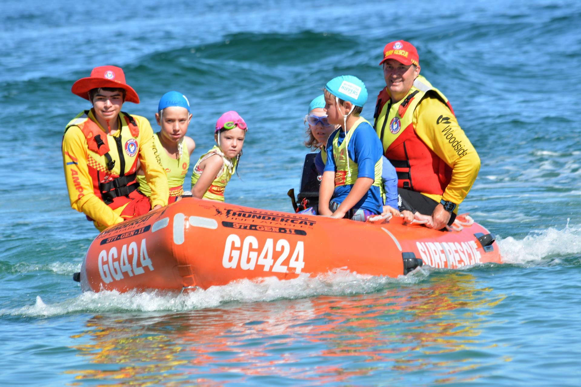 Surf Rescue boat with kids on water