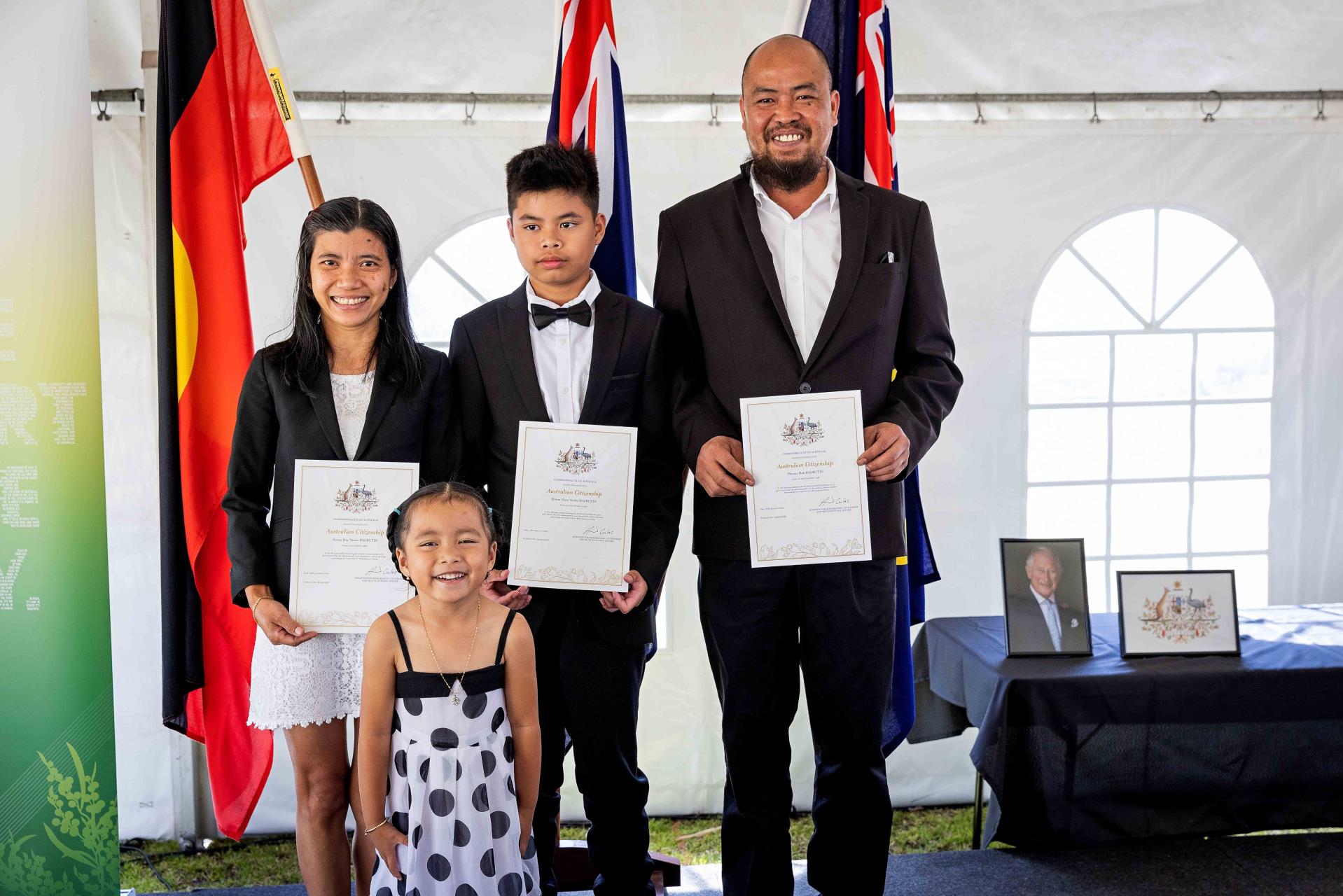 Family holding Citizenship certificates and Ceremony