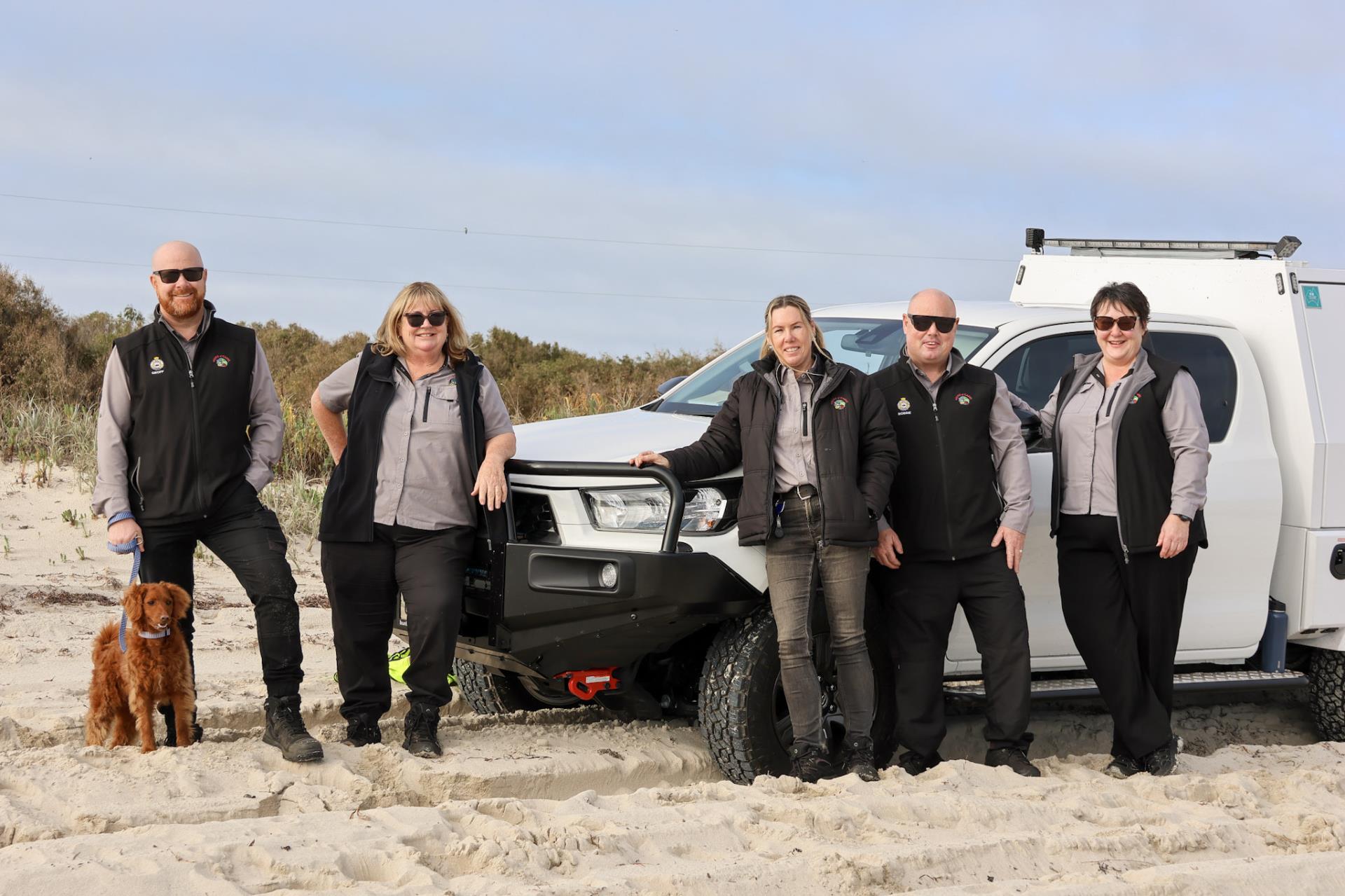 Ranger changing beach safety signs at beach