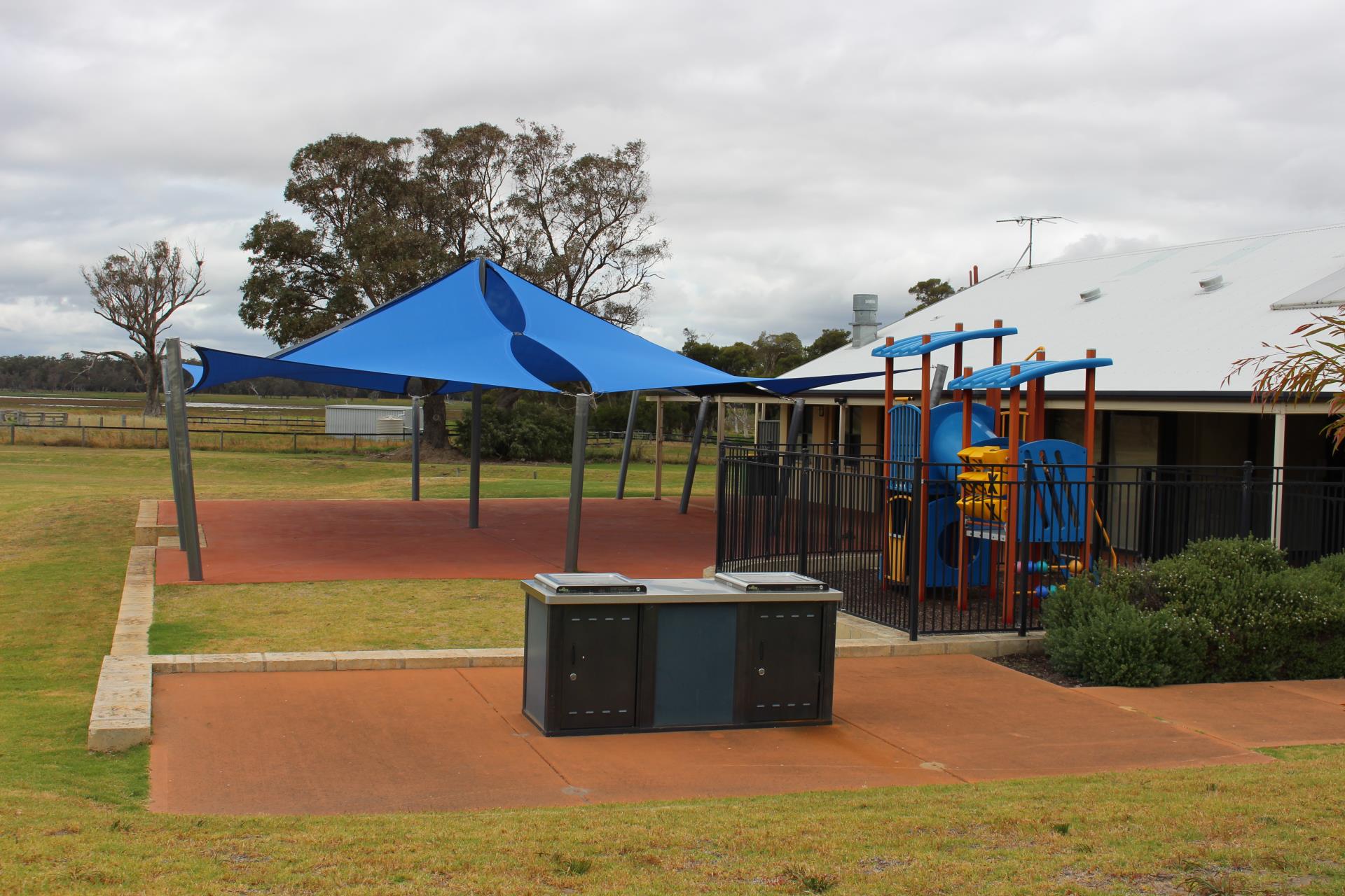 BBQs in a park with playground and shade sails